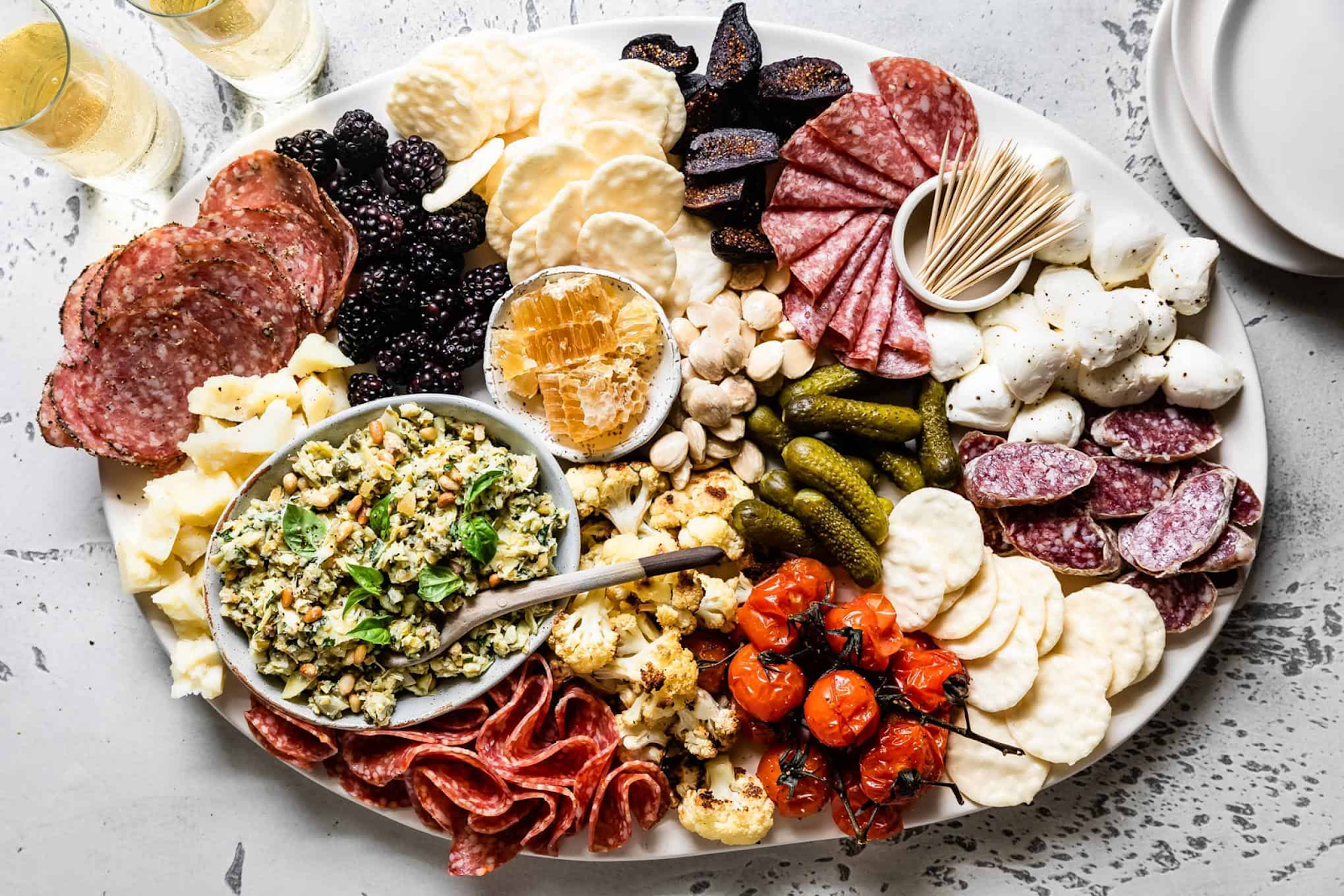 A classic charcuterie board filled with meats, cheeses, veggies and preserves.