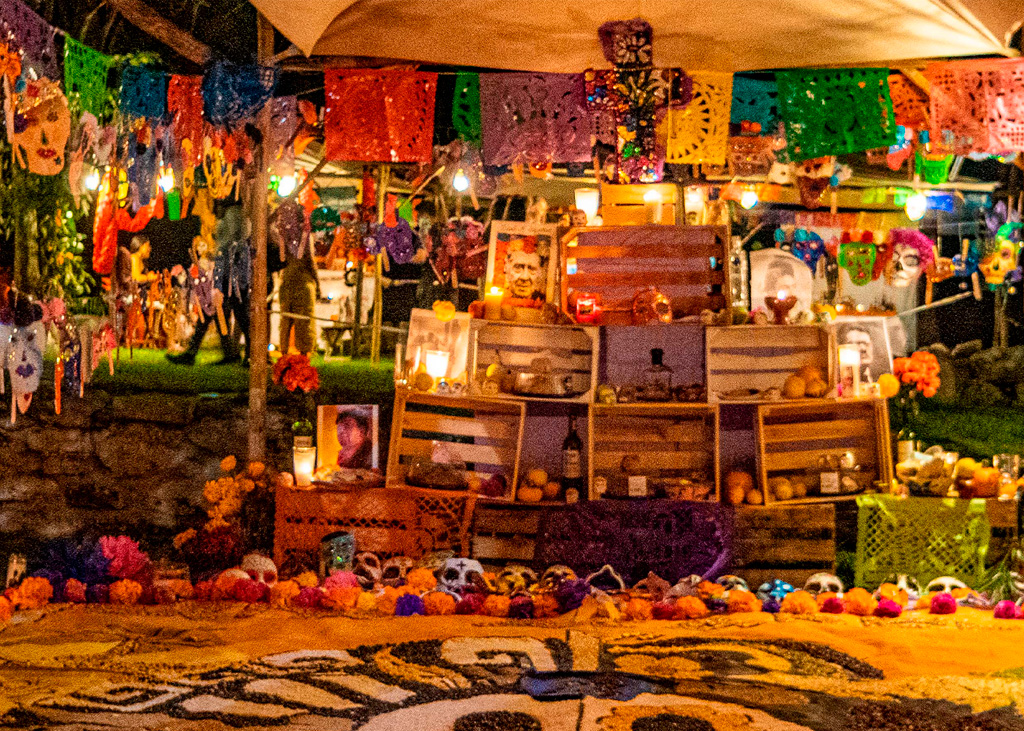 A modern-day Día de los Muertos or Day of the Dead ofrenda with classic cultural symbols.